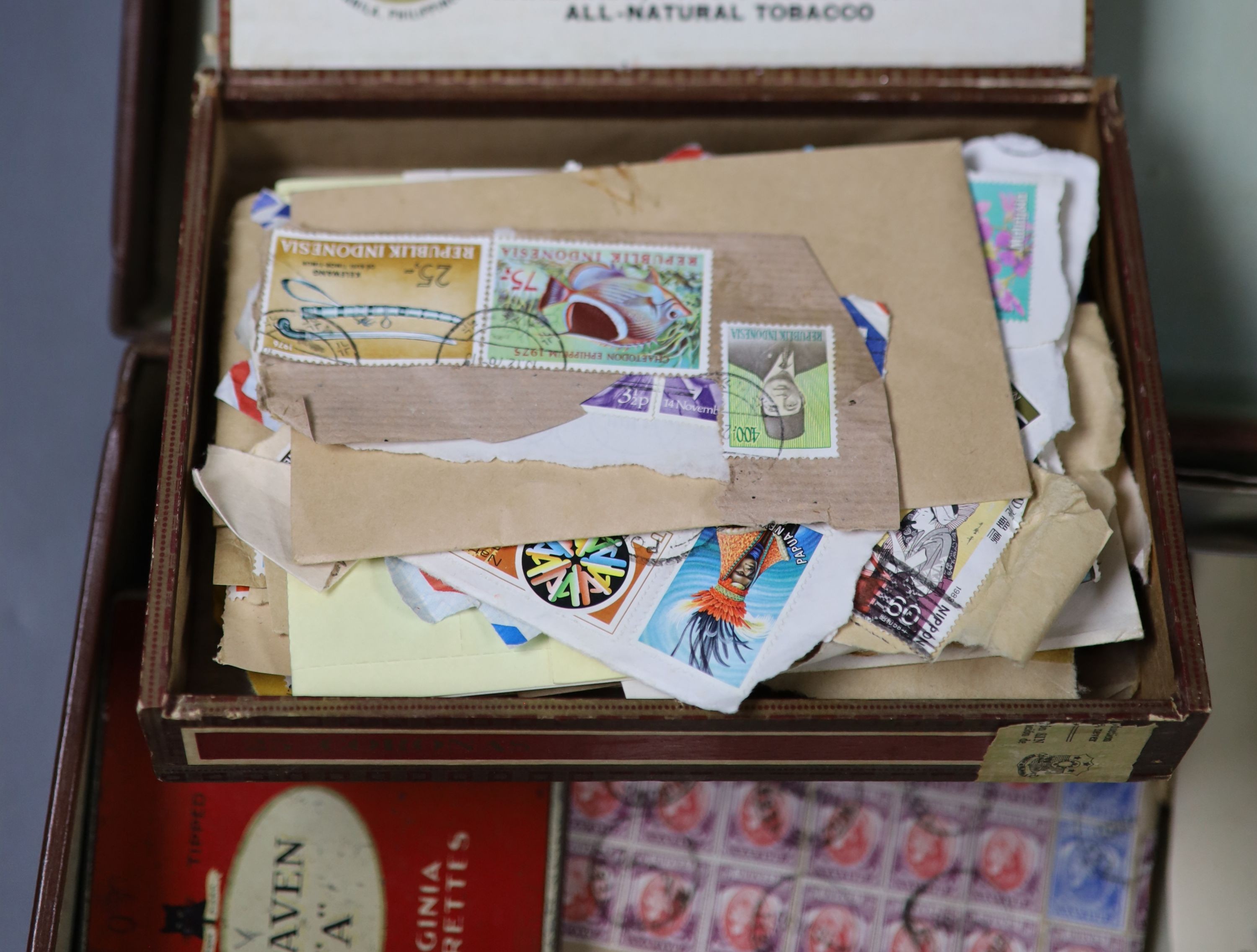 Four stamp albums and a small case containing loose stamps